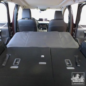 seat gap cover extender in gray shown from rear of car
