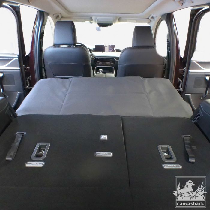 seat gap cover extender in gray shown from rear of car